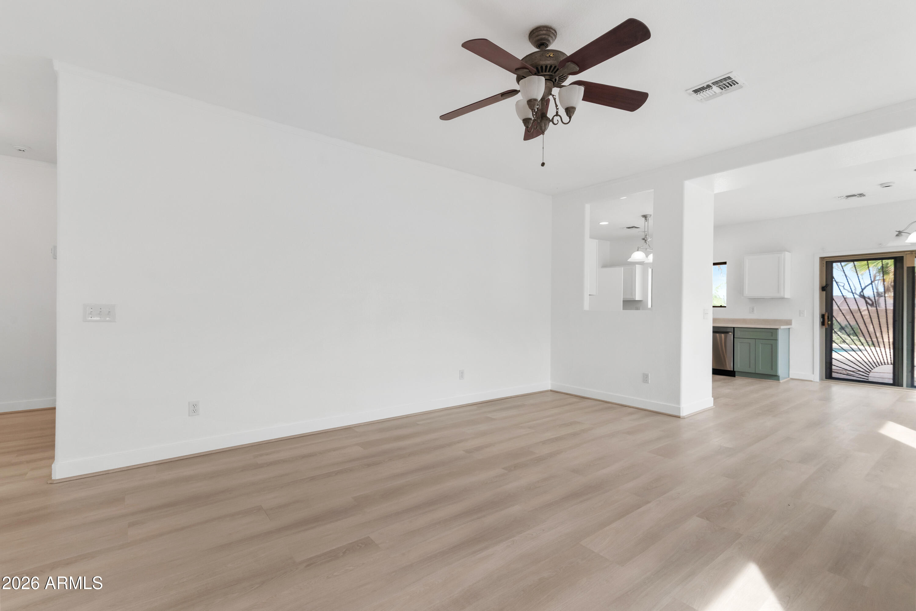 930 East Pedro Road Phoenix, AZ 85042 - Photo 6 of 34 an empty room with fan and a ceiling fan