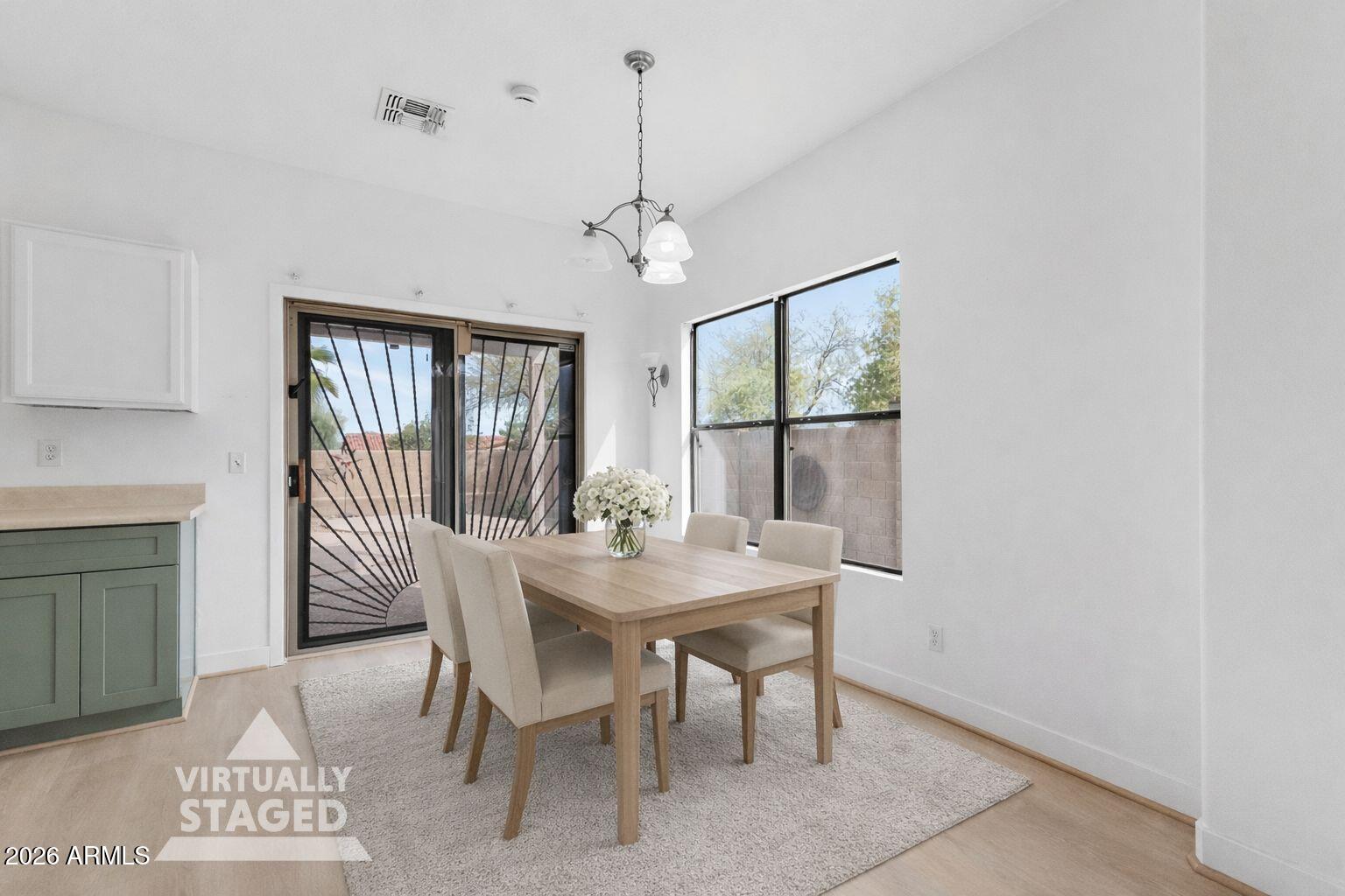 930 East Pedro Road Phoenix, AZ 85042 - Photo 7 of 34 a view of a dining room with furniture window and wooden floor