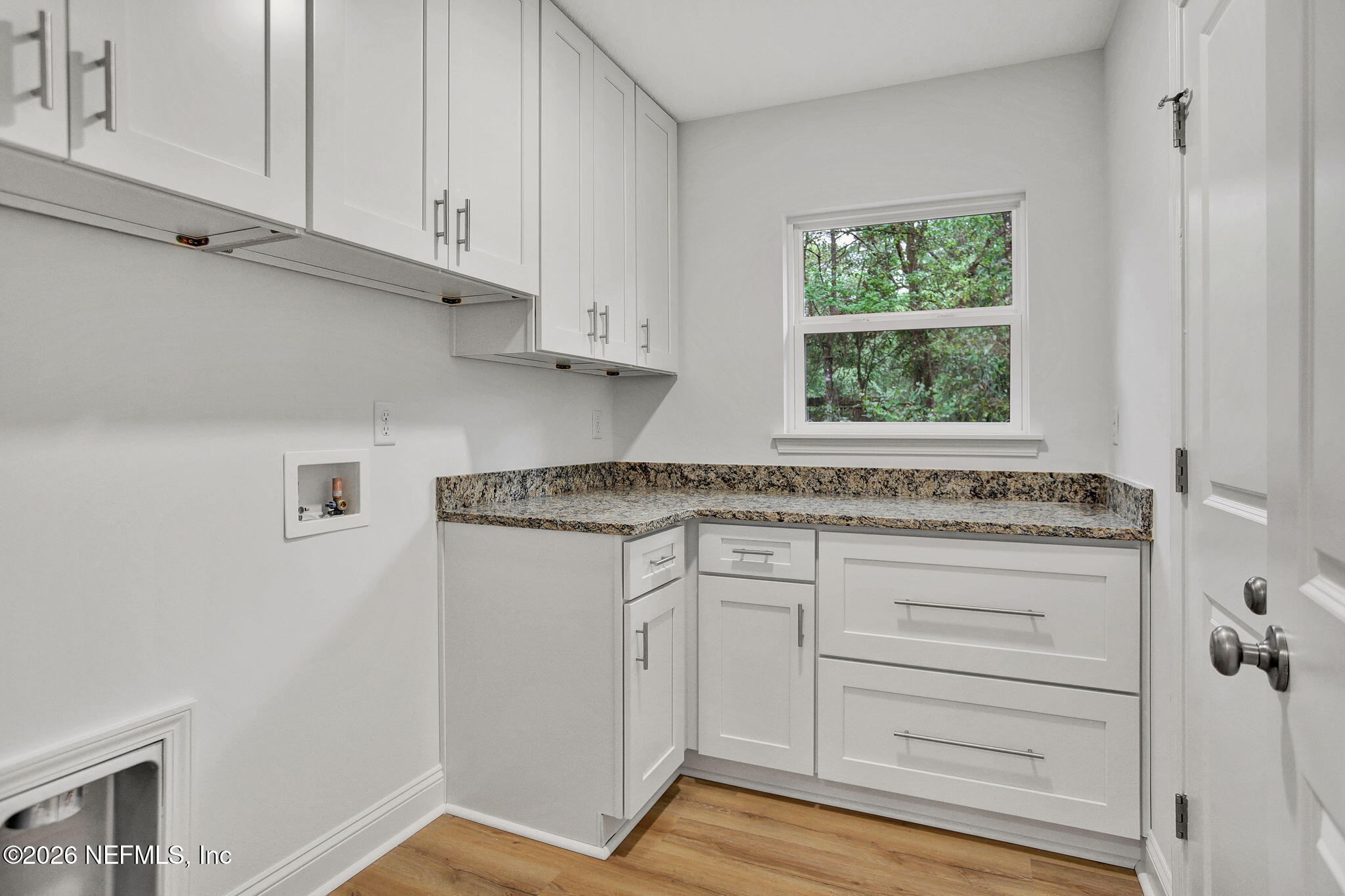 4881 Chickpea Street Middleburg, FL 32068 - Photo 13 of 19 a kitchen with granite countertop white cabinets and a window