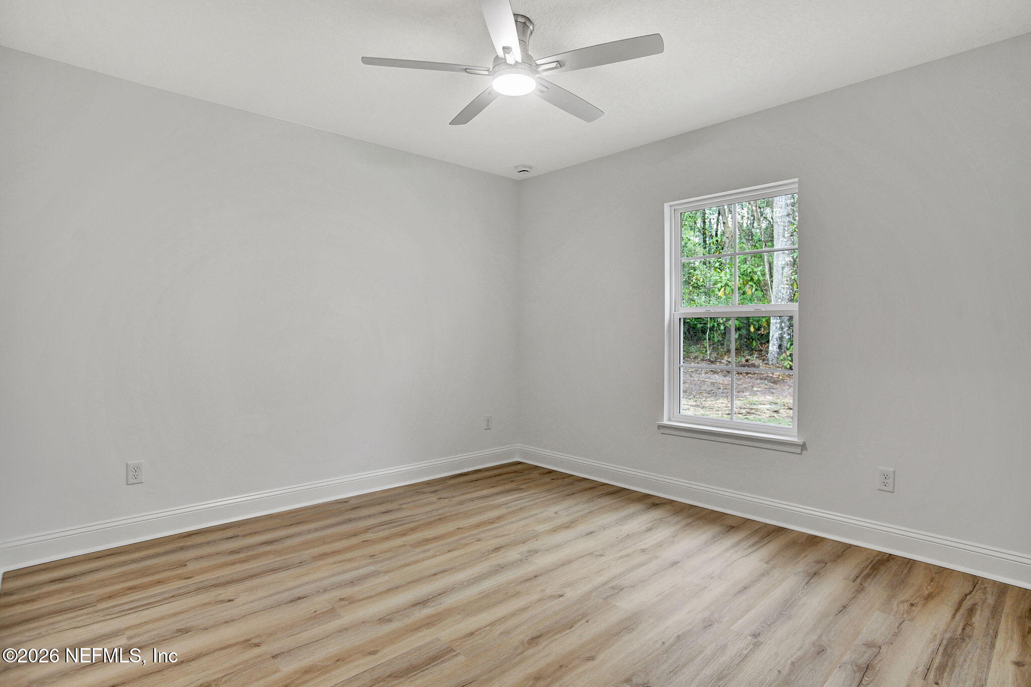 4881 Chickpea Street Middleburg, FL 32068 - Photo 17 of 19 an empty room with wooden floor and windows