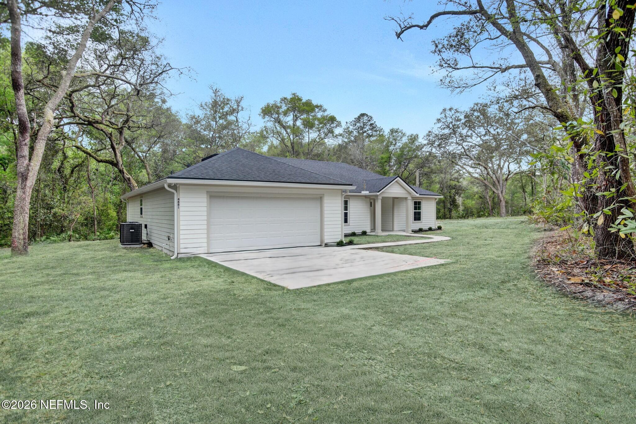 4881 Chickpea Street Middleburg, FL 32068 - Photo 2 of 19 a front view of house with yard and trees