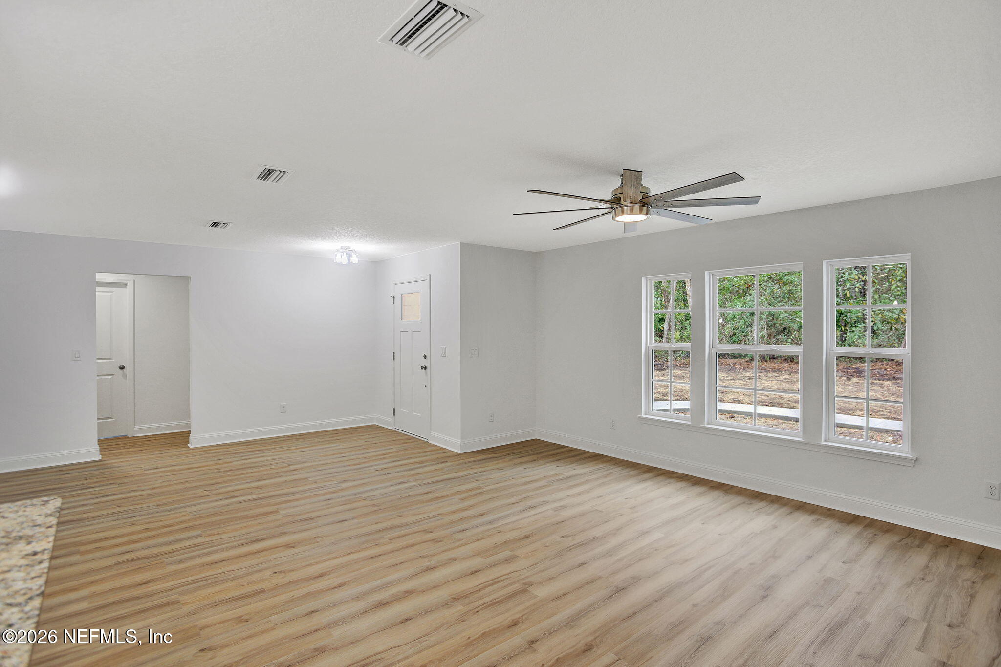 4881 Chickpea Street Middleburg, FL 32068 - Photo 7 of 19 wooden floor in an empty room with a window