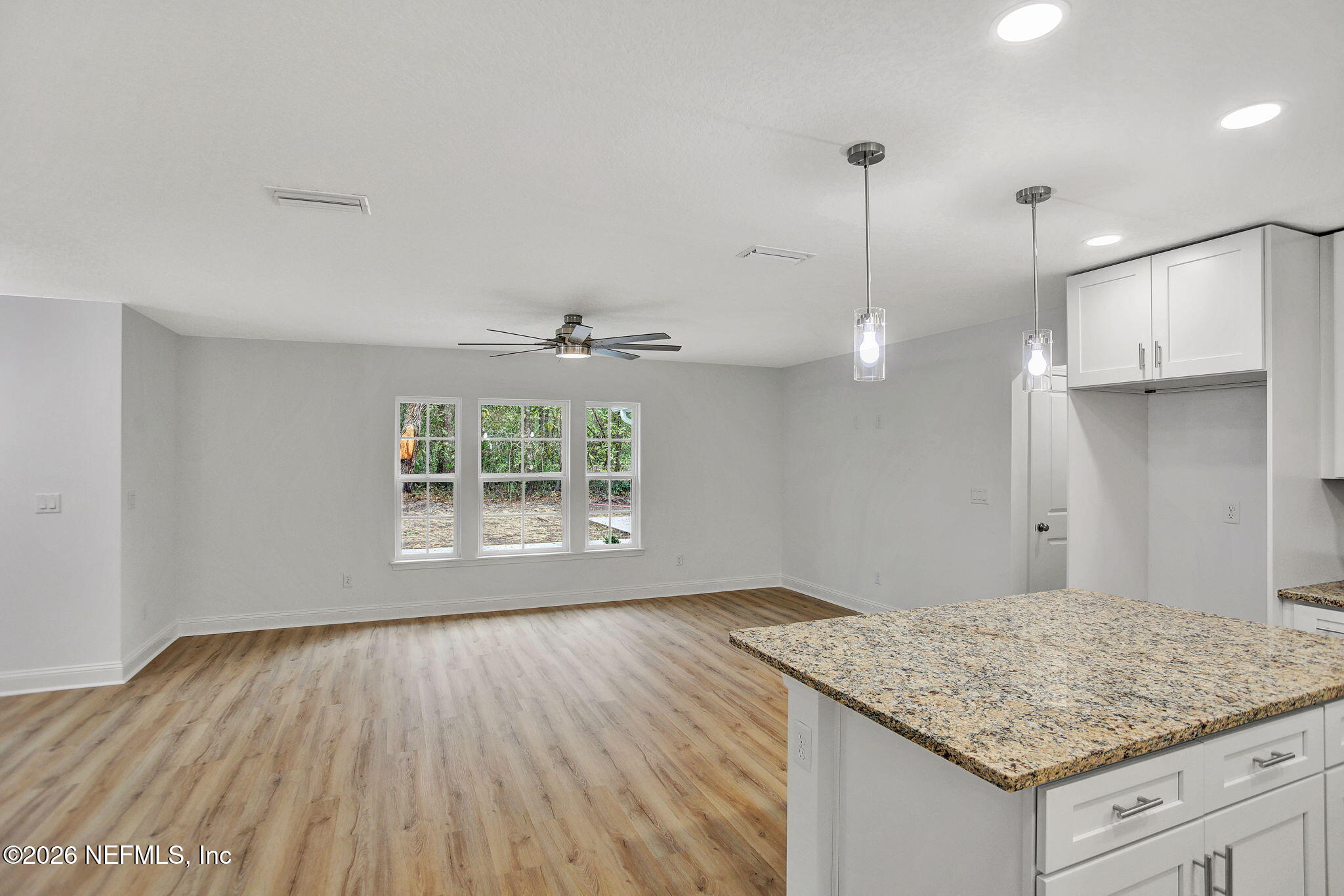 4881 Chickpea Street Middleburg, FL 32068 - Photo 8 of 19 a view of kitchen with granite countertop window and wooden floor