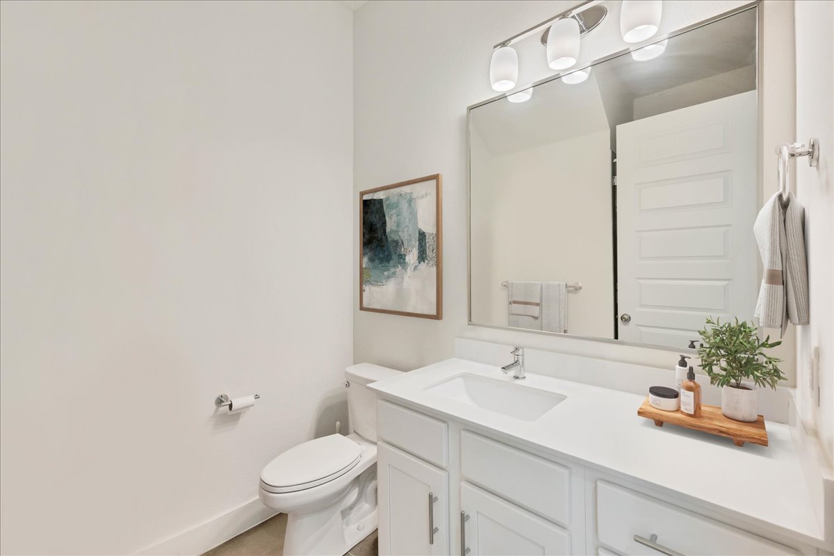 8922 Manchaca Road, Unit 906 Austin, TX 78748 - Photo 11 of 29 a bathroom with a sink a toilet and a mirror