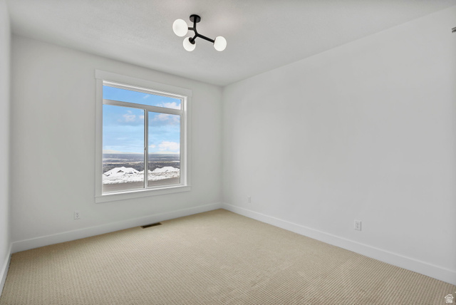 728 East Mountain Road North Ogden, UT 84414 - Photo 14 of 28 Bright room featuring a large window, neutral wall paint, and a modern ceiling light fixture
