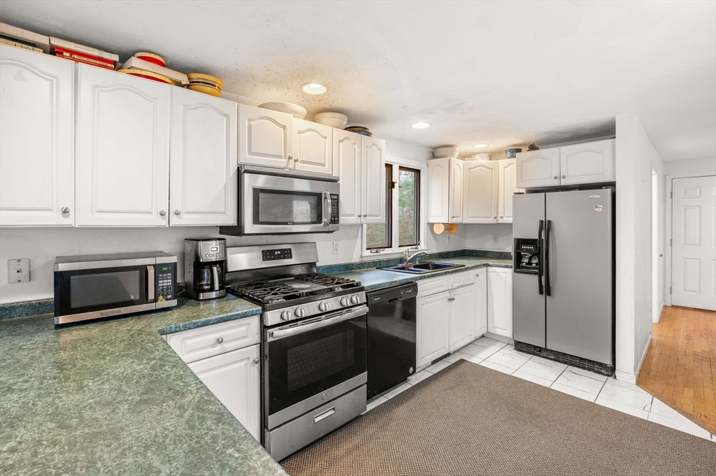 328 East Broadway Haverhill, MA 01830 - Photo 19 of 37 a kitchen with stainless steel appliances granite countertop a stove a sink and a refrigerator