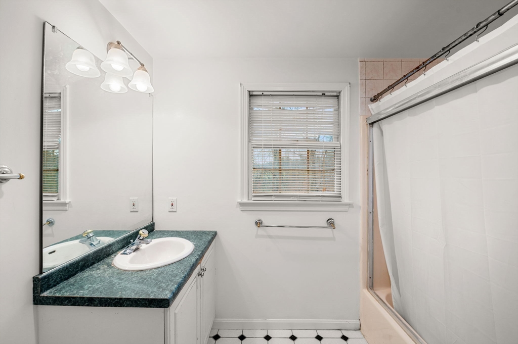 328 East Broadway Haverhill, MA 01830 - Photo 23 of 37 a bathroom with a granite countertop sink and a mirror