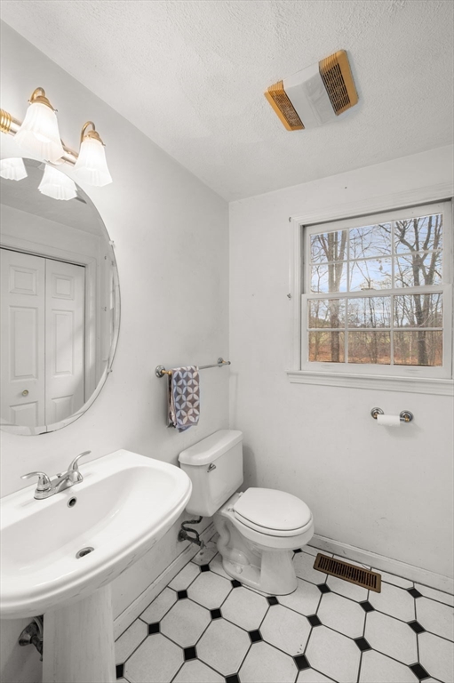 328 East Broadway Haverhill, MA 01830 - Photo 24 of 37 a bathroom with a sink a toilet and a mirror