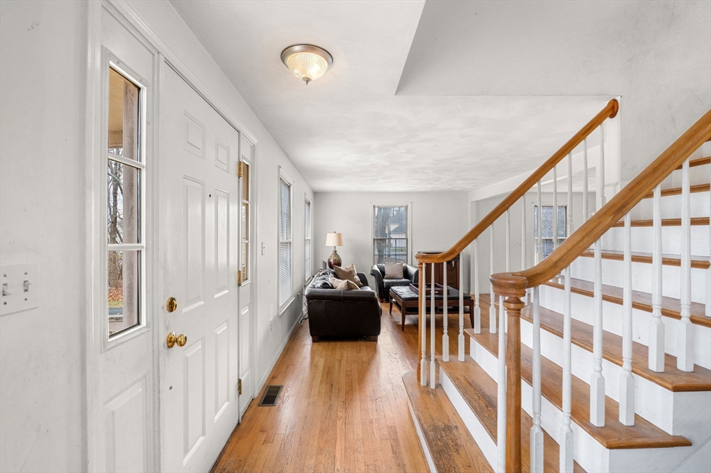 328 East Broadway Haverhill, MA 01830 - Photo 4 of 37 a view of a hallway with wooden floor and staircase