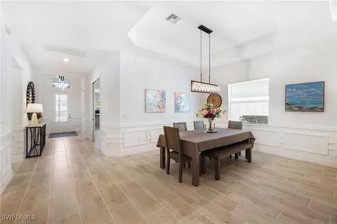 a bedroom with a bed and painting on the wall