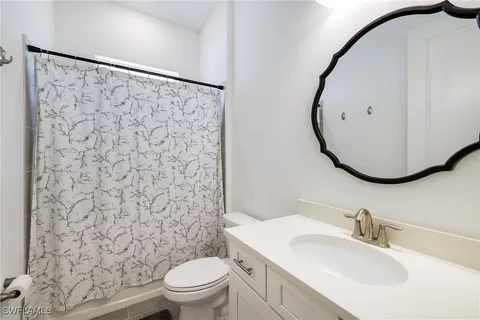 an aerial view of a house with swimming pool and outdoor seating