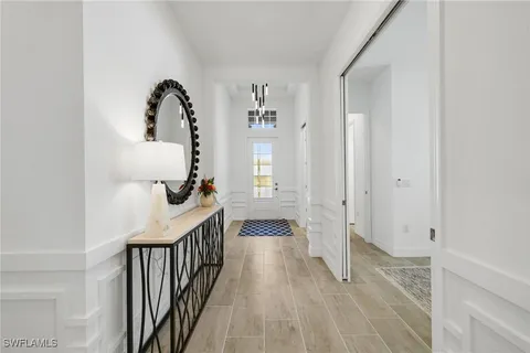 a kitchen with kitchen island granite countertop a stove a sink a kitchen island with a dining table and chairs