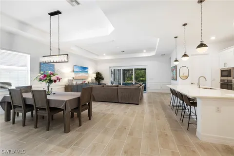 a open kitchen with stainless steel appliances granite countertop a sink a stove and a refrigerator