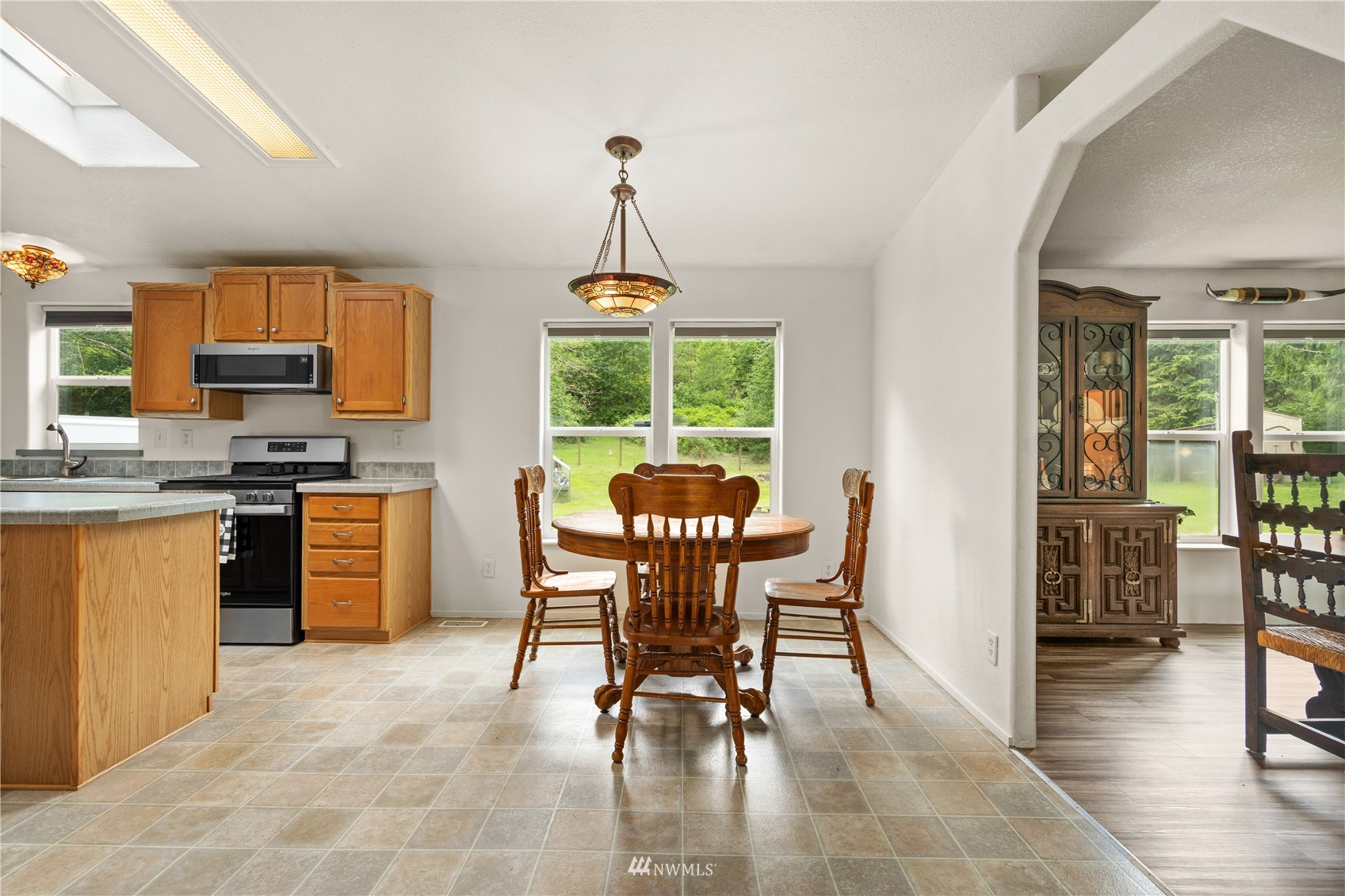 16227 OK Mill Road Snohomish, WA 98290 - Photo 12 of 38 a kitchen with stainless steel appliances granite countertop a table and chairs in it