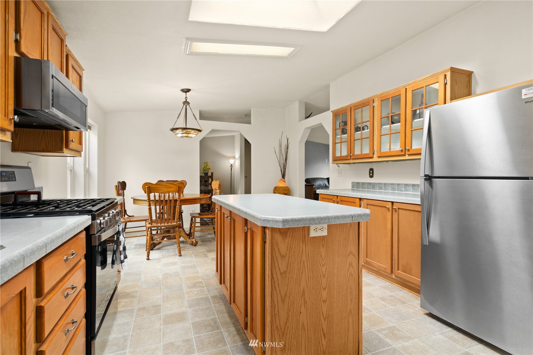 16227 OK Mill Road Snohomish, WA 98290 - Photo 18 of 38 a kitchen with stainless steel appliances granite countertop a sink stove and refrigerator