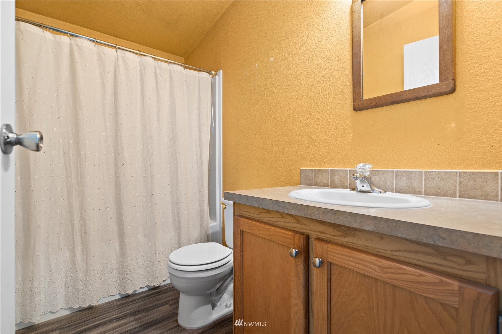 16227 OK Mill Road Snohomish, WA 98290 - Photo 24 of 38 a bathroom with a granite countertop sink a toilet and a mirror