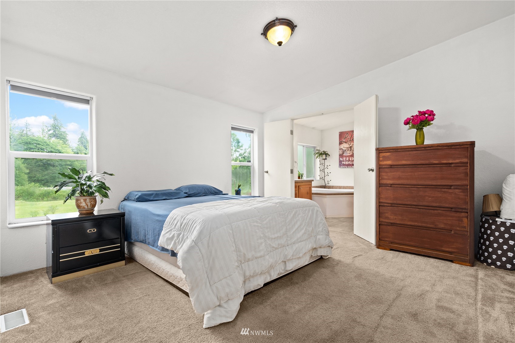 16227 OK Mill Road Snohomish, WA 98290 - Photo 25 of 38 a spacious bedroom with a bed and a cabinets