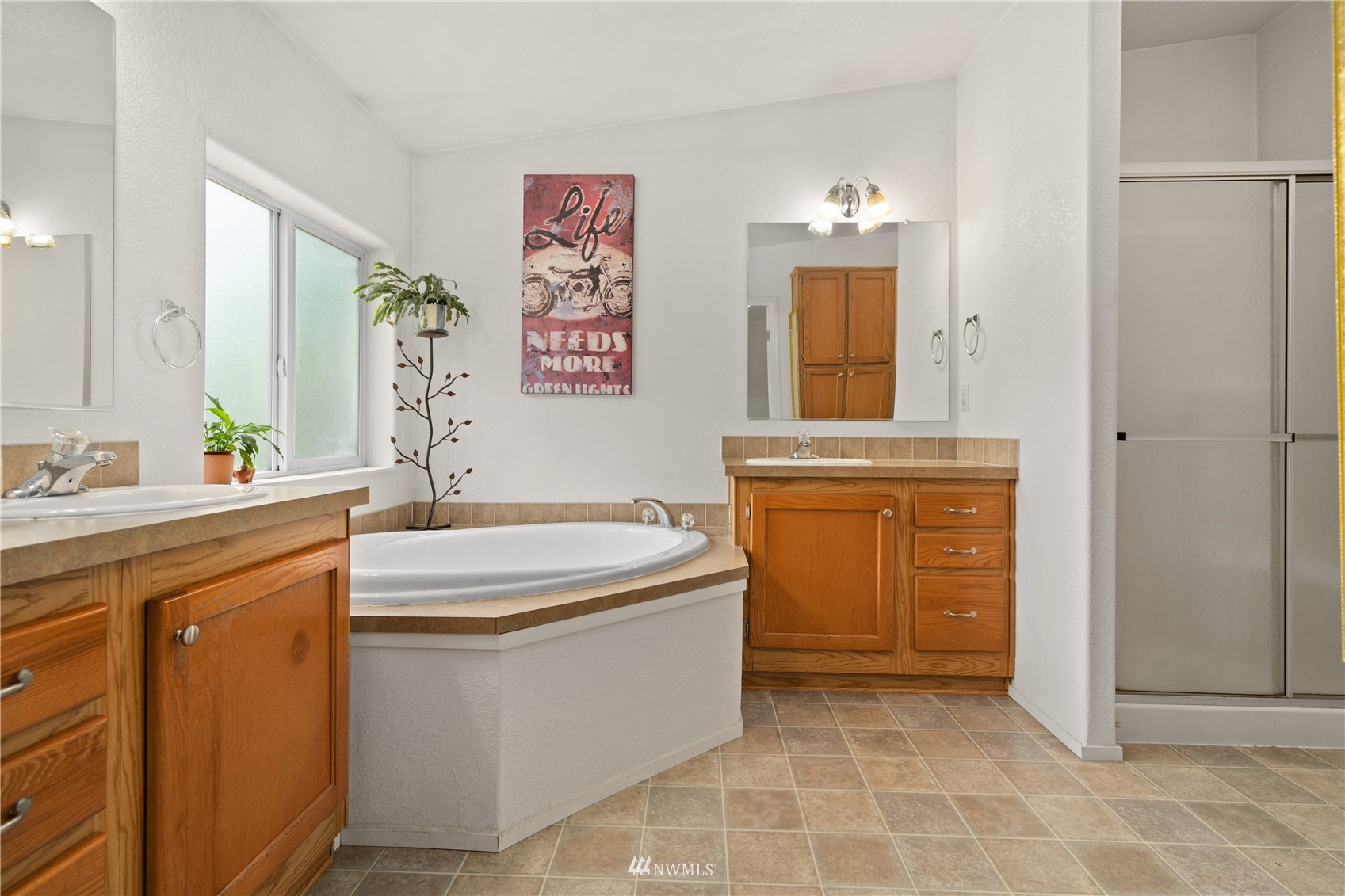 16227 OK Mill Road Snohomish, WA 98290 - Photo 26 of 38 a bathroom with a sink a bathtub and a shower