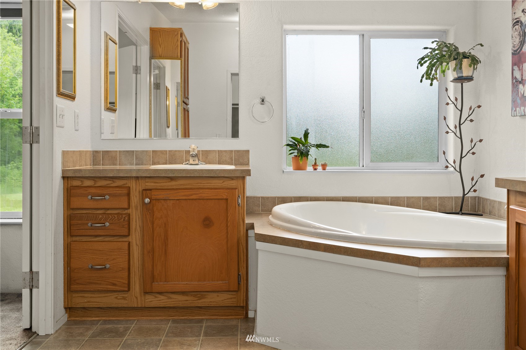 16227 OK Mill Road Snohomish, WA 98290 - Photo 27 of 38 a bathroom with a sink and a mirror
