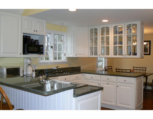 35 Colgate Road Newton, MA 02462 - Photo 3 of 17 a kitchen with granite countertop a sink a stove and cabinets