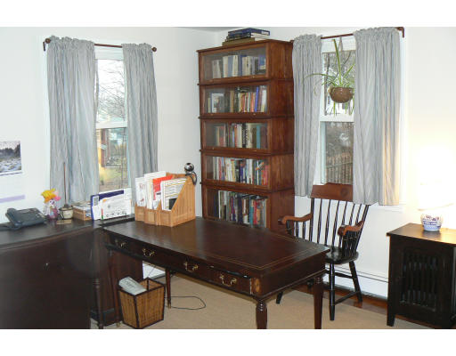 35 Colgate Road Newton, MA 02462 - Photo 10 of 17 a dining room with a table and a bookshelf