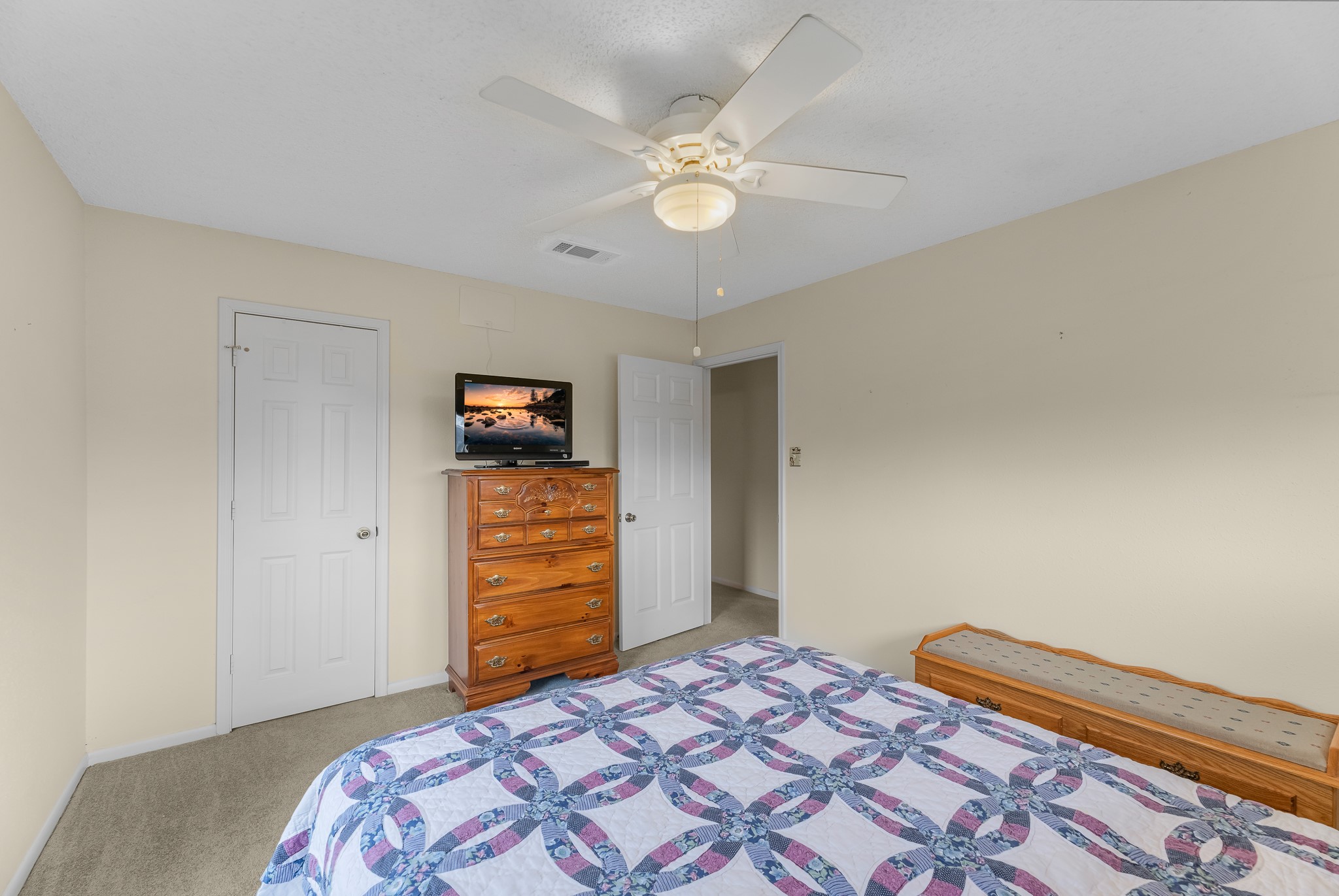7315 Pine Street Manvel, TX 77578 - Photo 22 of 50 a bedroom with a bed and a chandelier