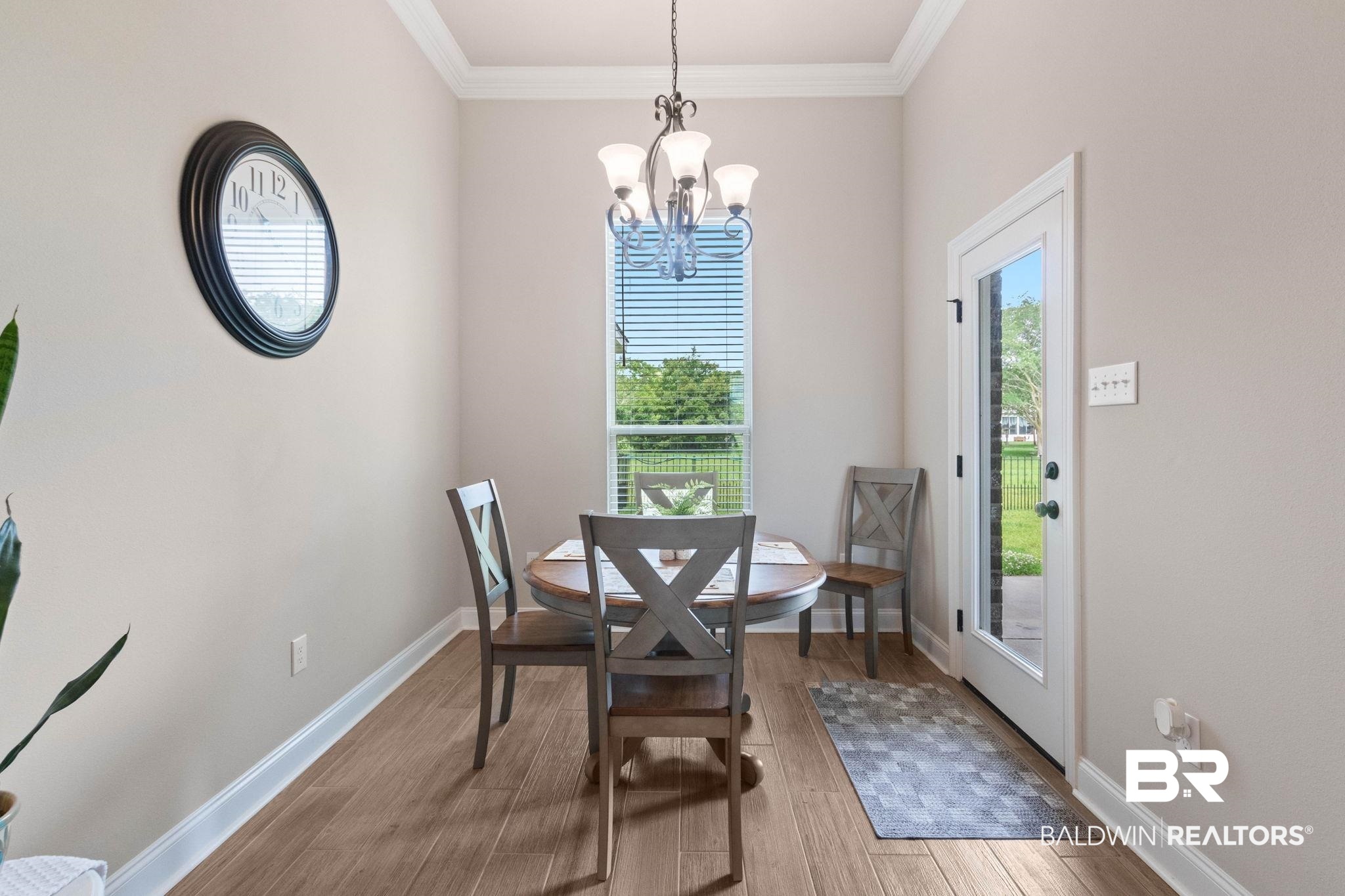 22244 Hibiscus Circle Foley, AL 36535 - Photo 33 of 51 Dining area featuring wood-finish flooring, a contemporary chandelier, and a full-light exterior door