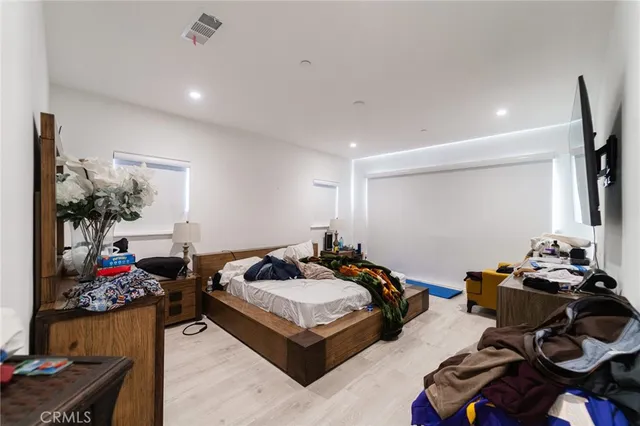 a bedroom with furniture a bed and a chandelier