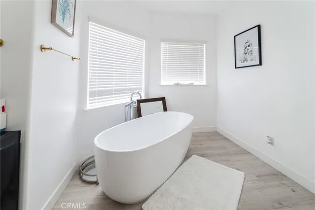 a white bath tub sitting next to a white sink