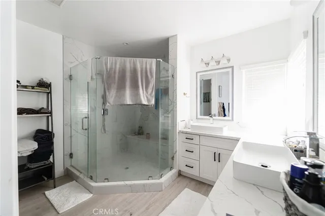a bathroom with a shower sink and mirror