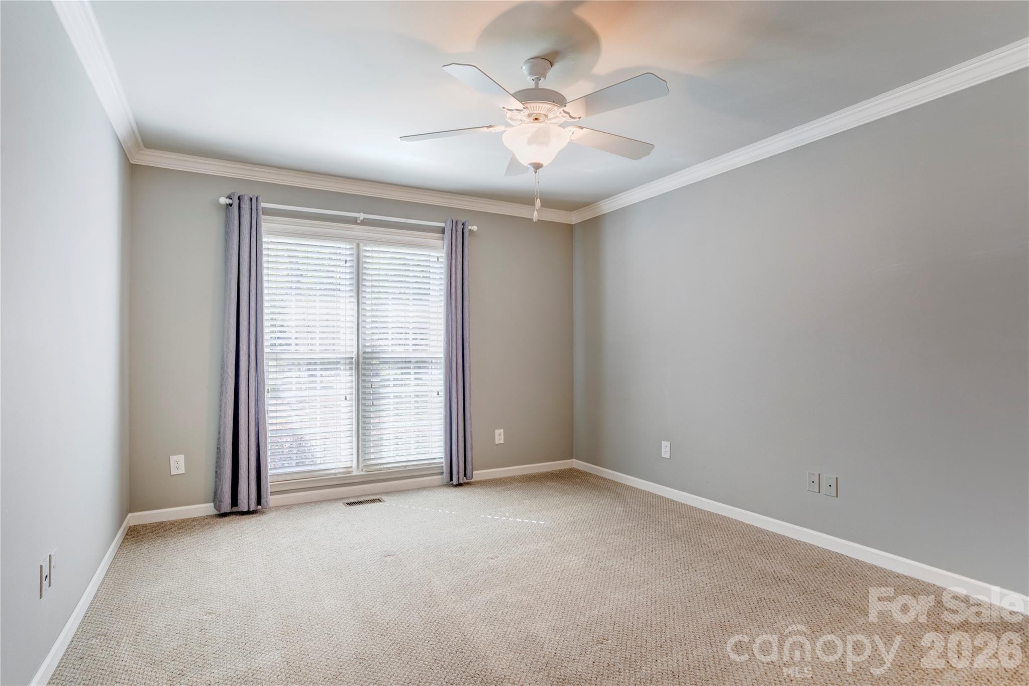 1188 Fawn Ridge Road Northwest Concord, NC 28027 - Photo 25 of 38 an empty room with chandelier fan and windows