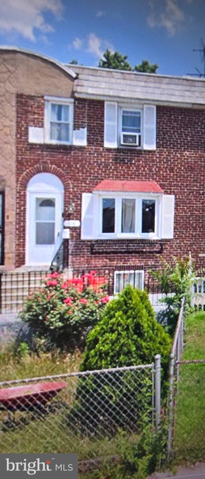 Charming brick home with vibrant garden.