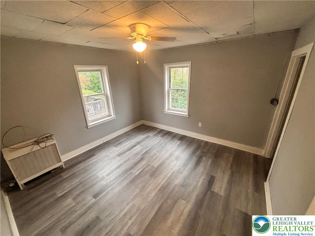 121 East Ridge Street Coaldale, PA 18218 - Photo 7 of 10 a view of an empty room with a window and wooden floor