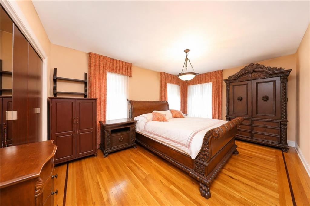 1 Bay Ridge Parkway Brooklyn, NY 11209 - Photo 18 of 38 a spacious bedroom with a bed dresser and a large window