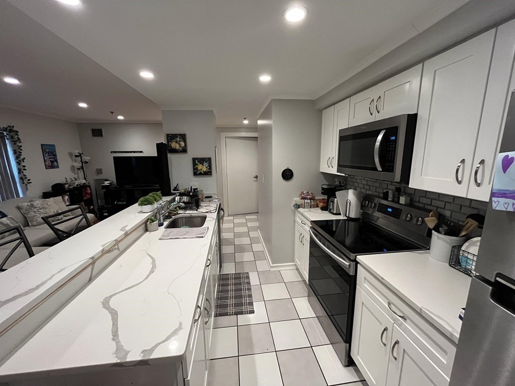 a kitchen with a sink a stove and a microwave