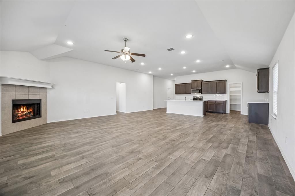 3807 Dogwood Road Melissa, TX 75454 - Photo 12 of 38 a view of a kitchen with a sink and a fireplace