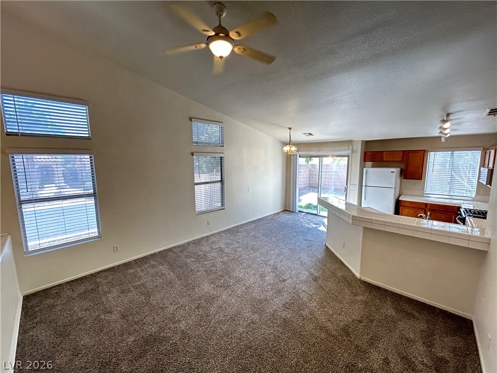 1840 Montvale Las Vegas, NV 89134 - Photo 6 of 31 A combined living area with an open kitchen and sliding glass doors to a private yard.