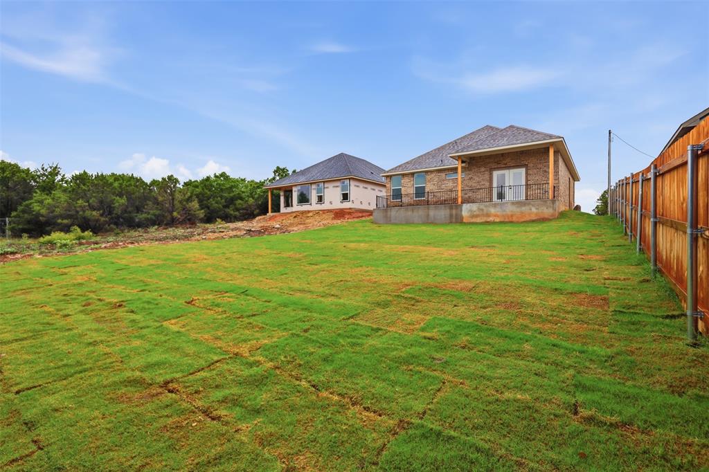 1413 Ridgeview Circle Granbury, TX 76048 - Photo 28 of 35 Expansive green lawn with newly laid sod provides a sizable exterior space