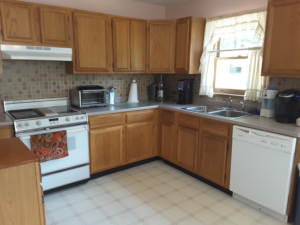42 Cummings Road Ware, MA 01082 - Photo 14 of 28 a kitchen with stainless steel appliances granite countertop a sink a stove a refrigerator with grey cabinets