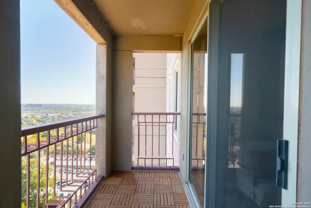 a view of a balcony with wooden floor