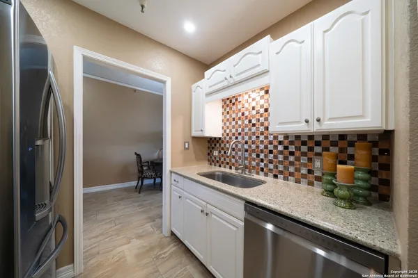 a kitchen with sink and cabinets