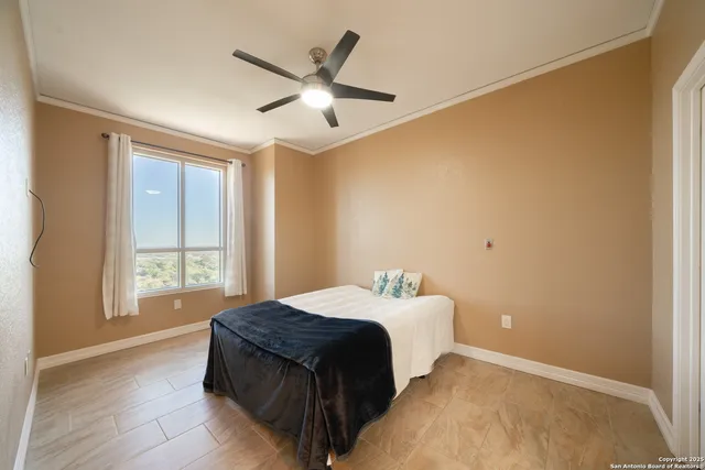 a bedroom with a large bed and a window