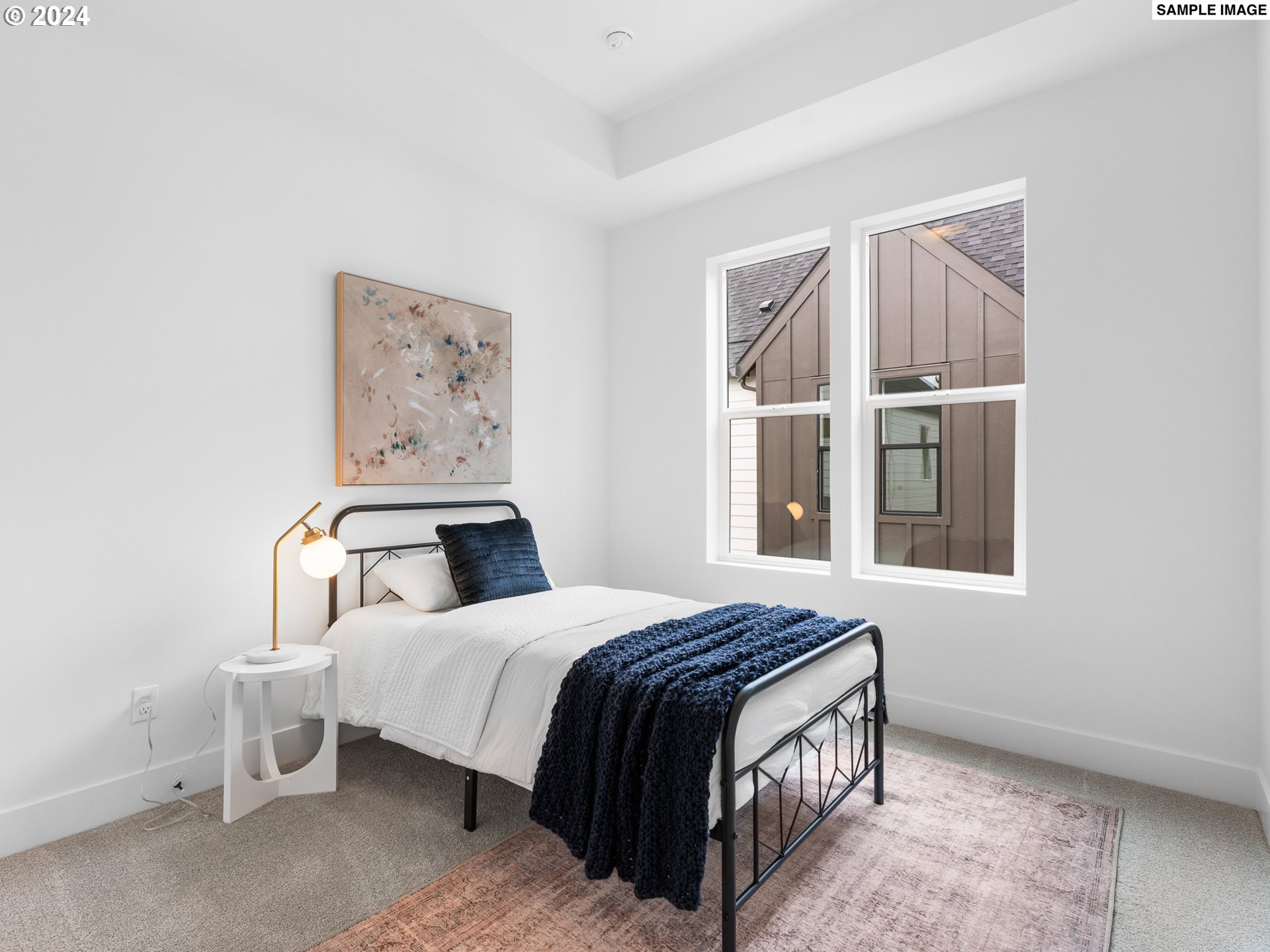 6195 North Amherst Street Portland, OR 97203 - Photo 8 of 20 a bedroom with a bed next to a window