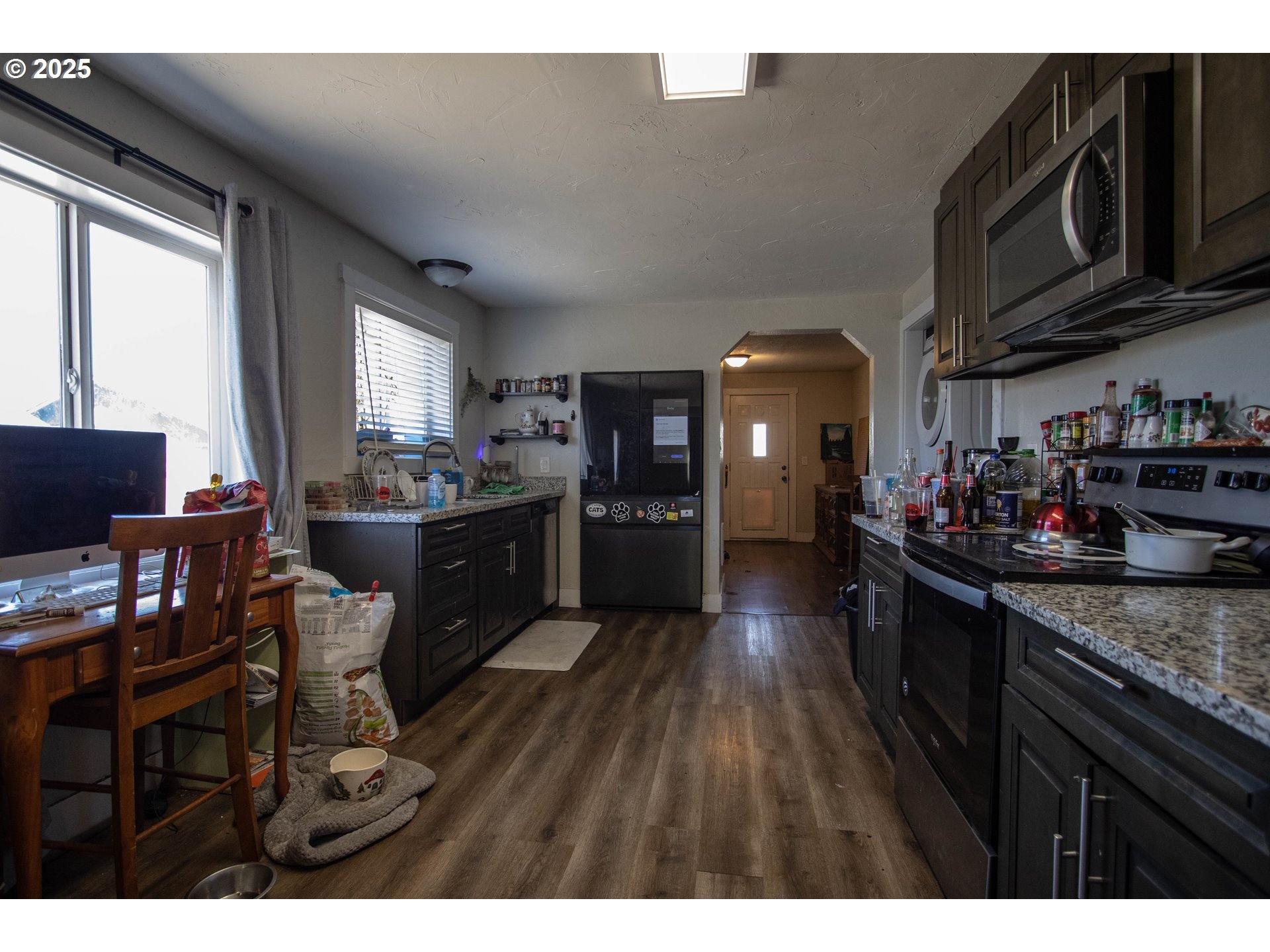 2343 31st Street Springfield, OR 97477 - Photo 5 of 12 a kitchen with stainless steel appliances granite countertop a stove a sink dishwasher and cabinets with wooden floor