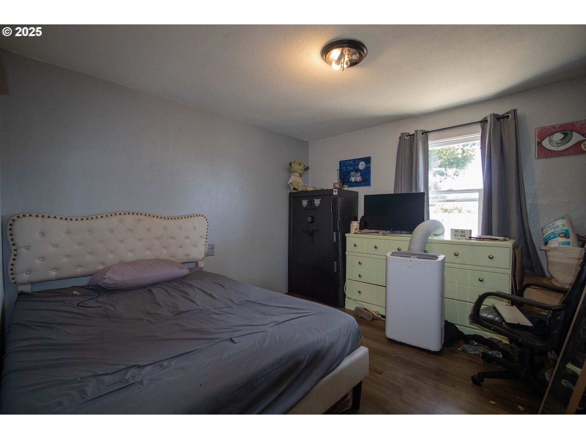 2343 31st Street Springfield, OR 97477 - Photo 8 of 12 a bedroom with a bed and wooden floor