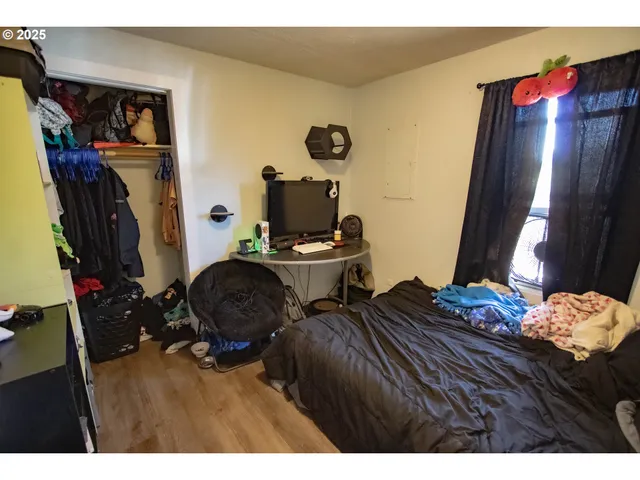 a bedroom with bed and a window