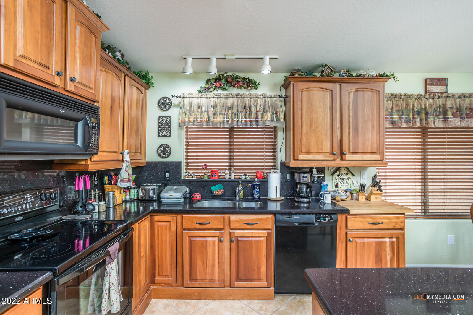 45083 West Norris Road Maricopa, AZ 85139 - Photo 15 of 35 a kitchen with stainless steel appliances granite countertop a stove a sink and a microwave
