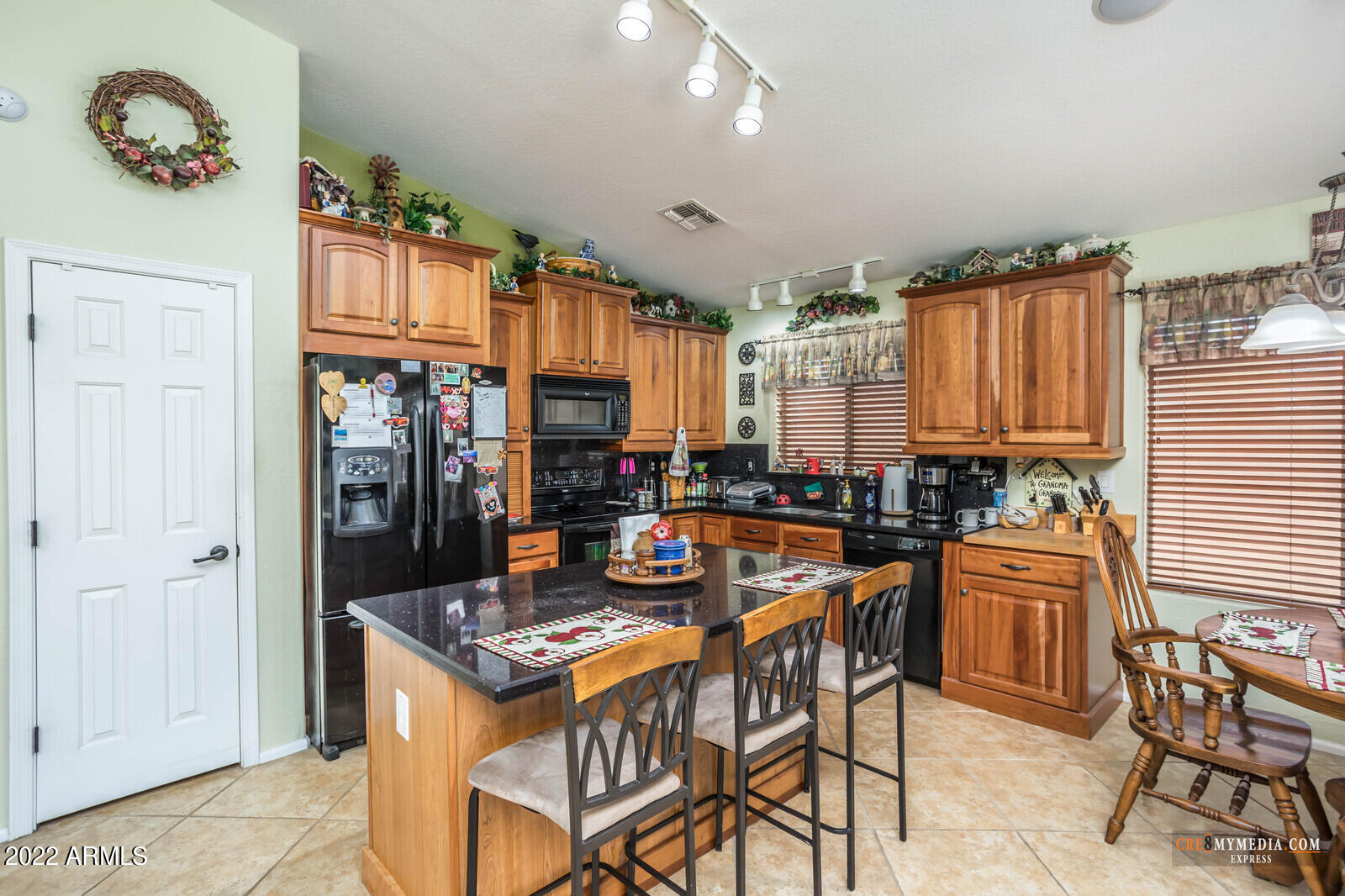 45083 West Norris Road Maricopa, AZ 85139 - Photo 16 of 35 a kitchen with a stove a refrigerator and a dining table