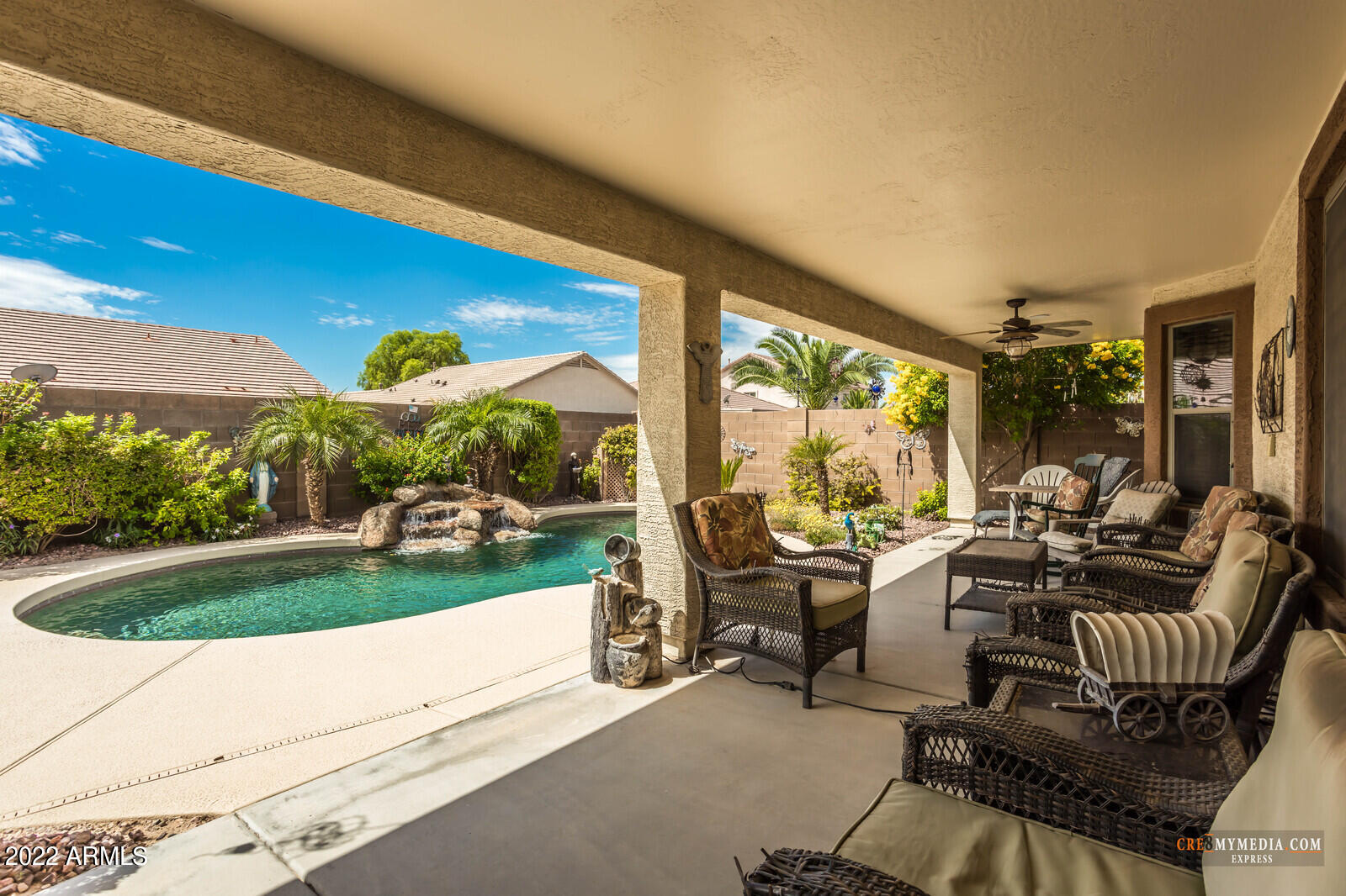 45083 West Norris Road Maricopa, AZ 85139 - Photo 31 of 35 a view of a patio with couches chairs and floor to ceiling window