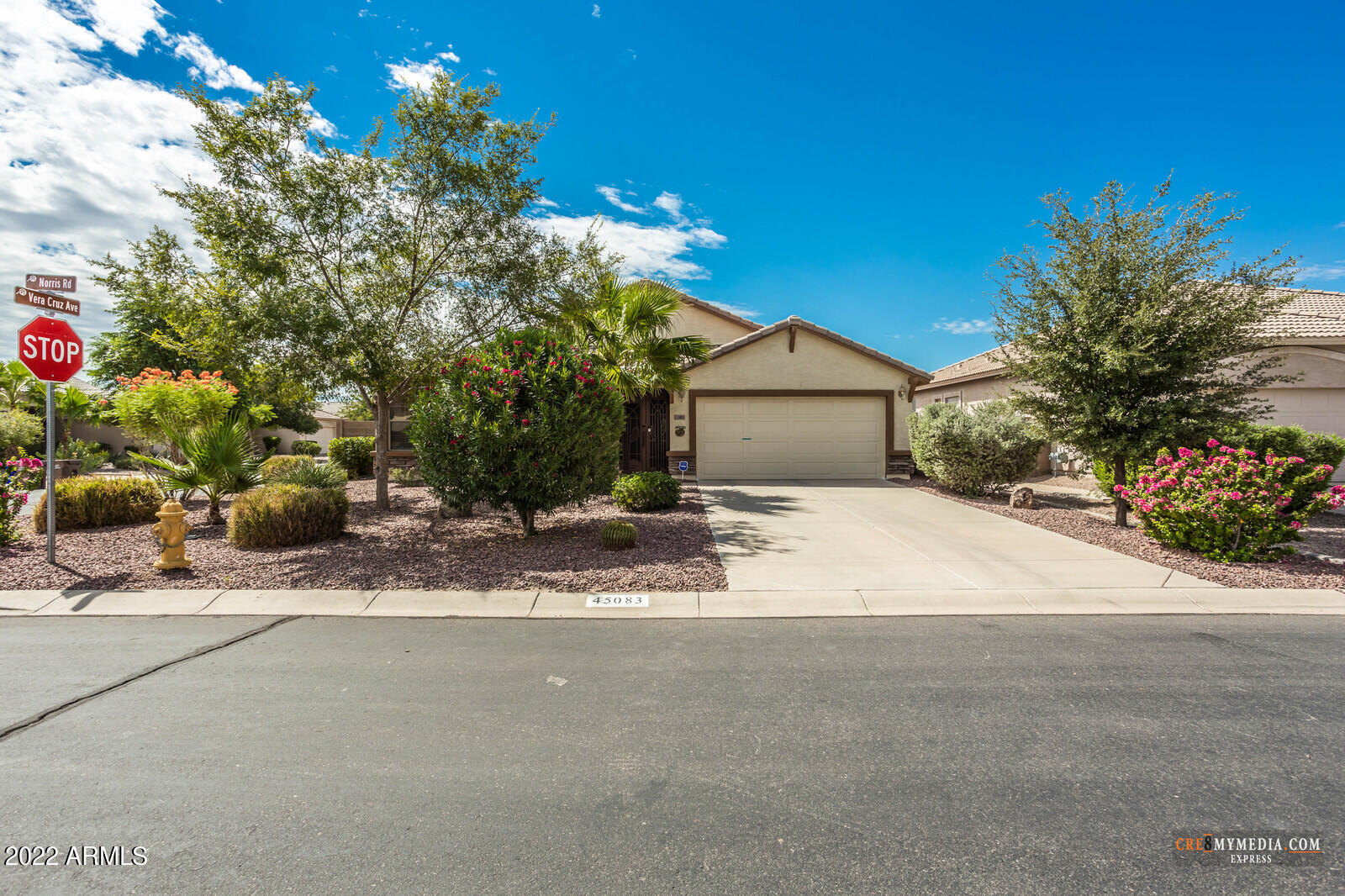 45083 West Norris Road Maricopa, AZ 85139 - Photo 6 of 35 a front view of a house with a yard and a garage